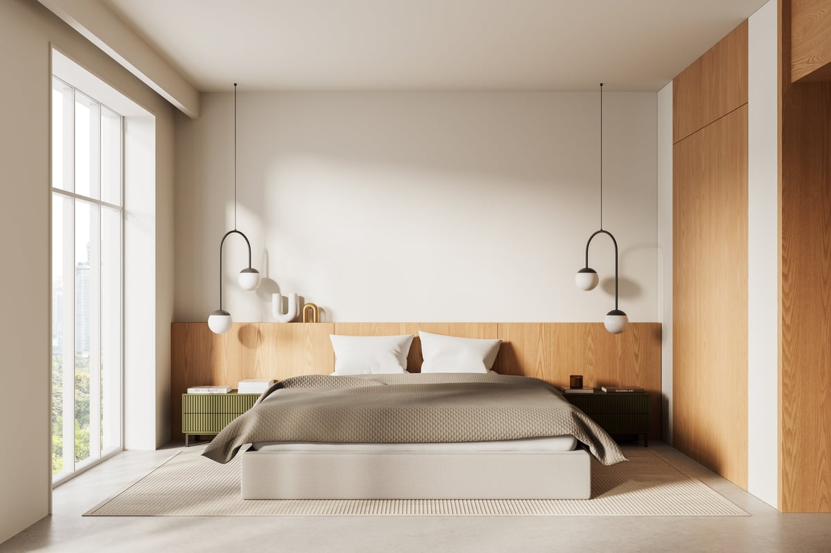 Cozy modern bedroom in soft beige tones with warm window light