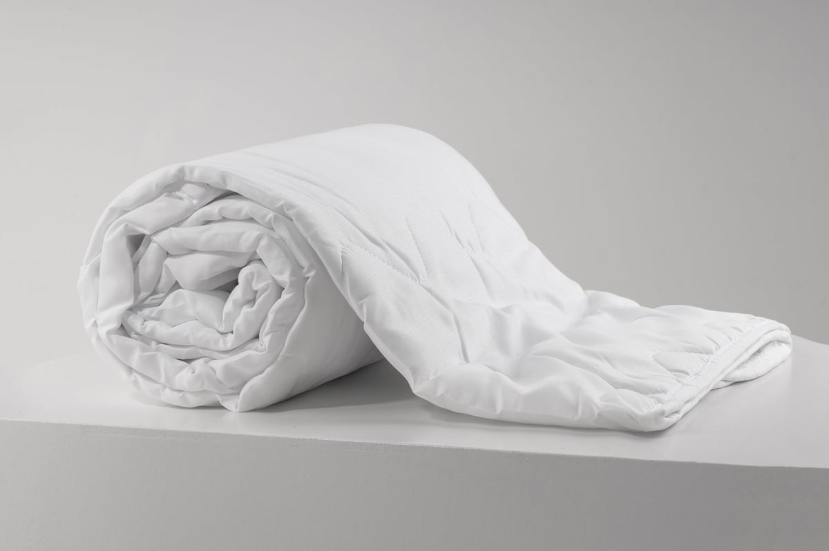 Close-up of quilted bed linen showing the stitched fabric texture